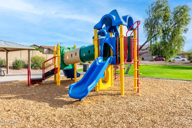 a view of a park with swings and a slide