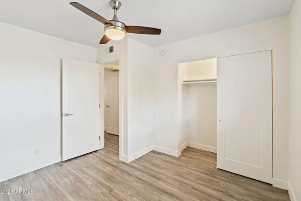 a kitchen with wooden floors and stainless steel appliances