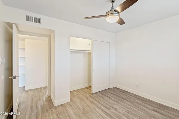 a view of an empty room with wooden floor
