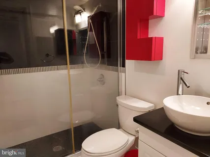 a bathroom with a toilet a sink and mirror