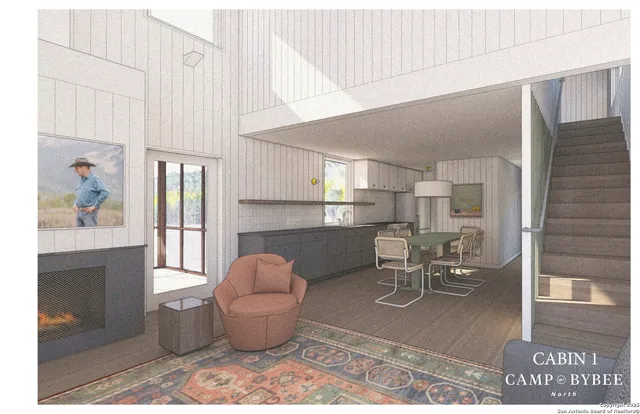 a living room with furniture a window and kitchen view