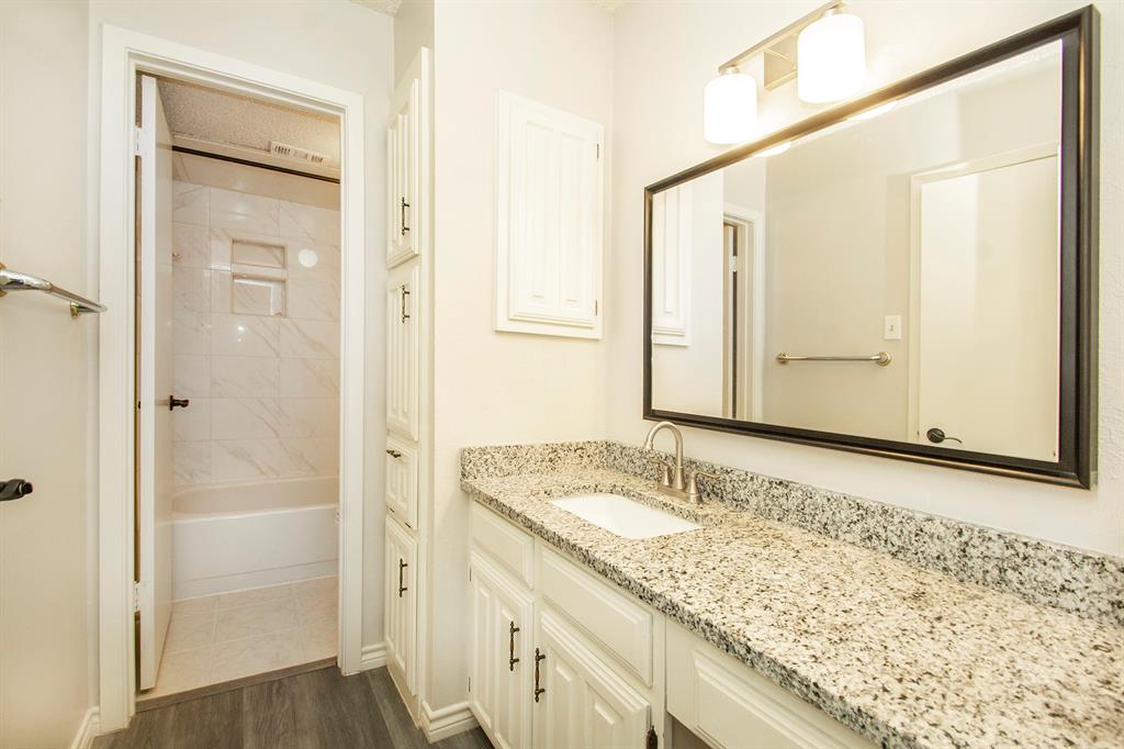 5626 Preston Oaks Road, Unit 9B Dallas, TX 75254 - Photo 16 of 20 a bathroom with a granite countertop sink and a mirror