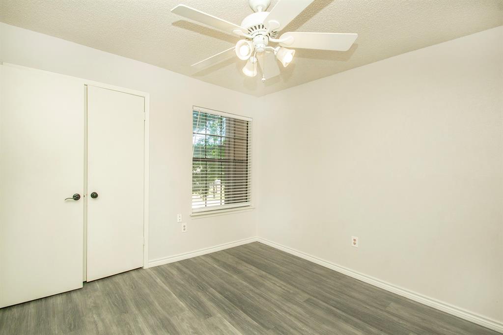 5626 Preston Oaks Road, Unit 9B Dallas, TX 75254 - Photo 17 of 20 an empty room with wooden floor fan and windows