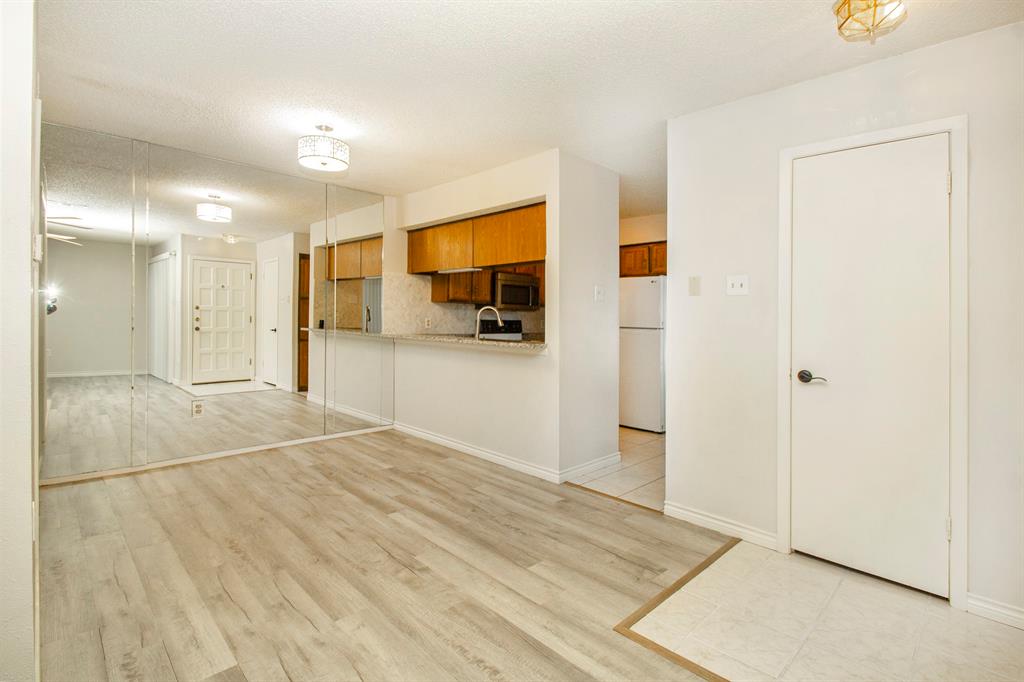 5626 Preston Oaks Road, Unit 9B Dallas, TX 75254 - Photo 6 of 20 a view of a livingroom with wooden floor