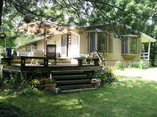 695 Lake Summerset Road Lake Summerset, IL 61019 - Photo 1 of 11 a front view of a house with a garden and chairs