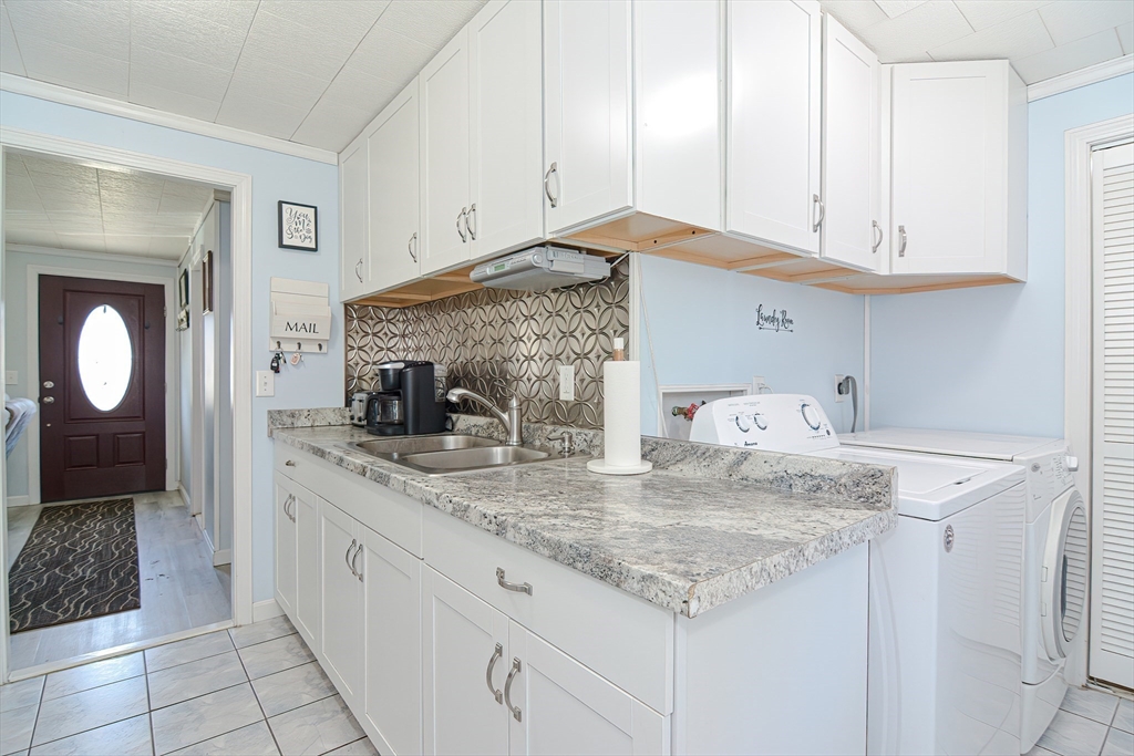 221 Smoke Rise Circle Swansea, MA 02777 - Photo 11 of 25 a kitchen with granite countertop a sink and cabinets