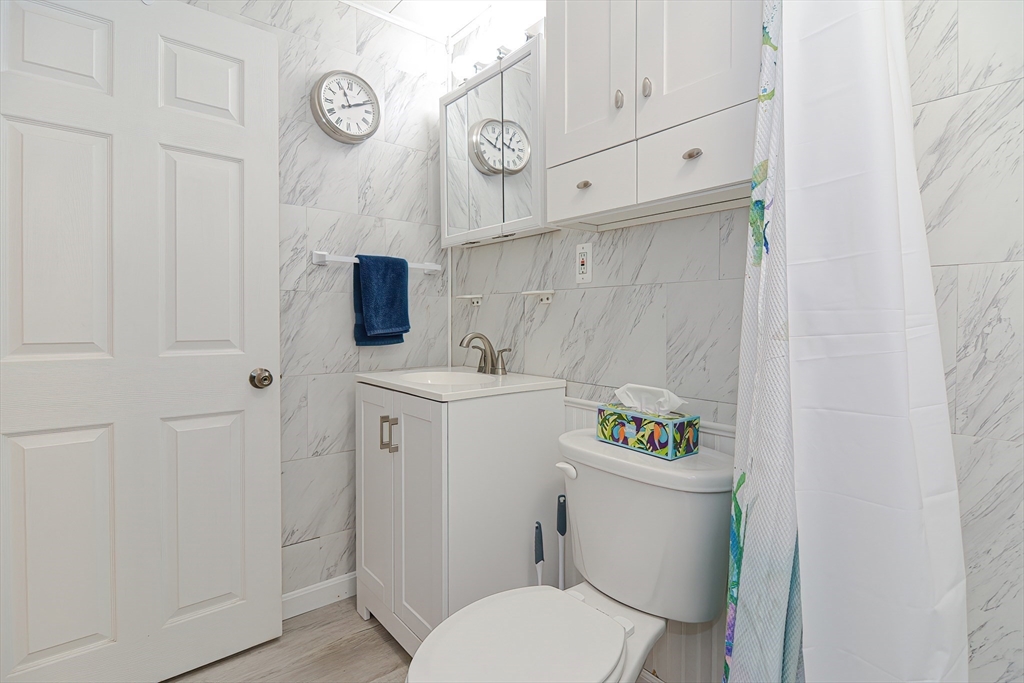 221 Smoke Rise Circle Swansea, MA 02777 - Photo 13 of 25 a bathroom with a sink a toilet and a mirror