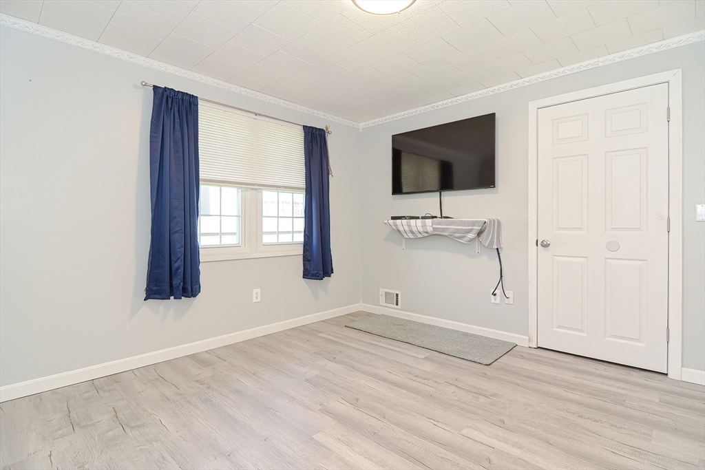 221 Smoke Rise Circle Swansea, MA 02777 - Photo 15 of 25 an empty room with windows and cabinet