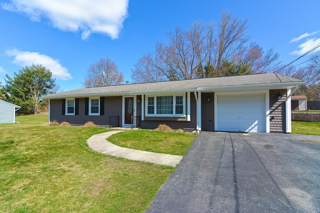221 Smoke Rise Circle Swansea, MA 02777 - Photo 2 of 25 a front view of a house with a yard and porch