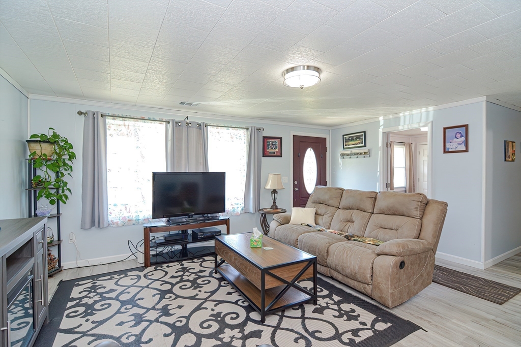 221 Smoke Rise Circle Swansea, MA 02777 - Photo 4 of 25 a living room with furniture and a flat screen tv