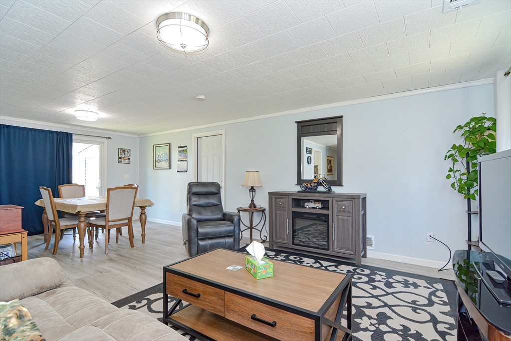221 Smoke Rise Circle Swansea, MA 02777 - Photo 5 of 25 a living room with furniture a dining table and a potted plant