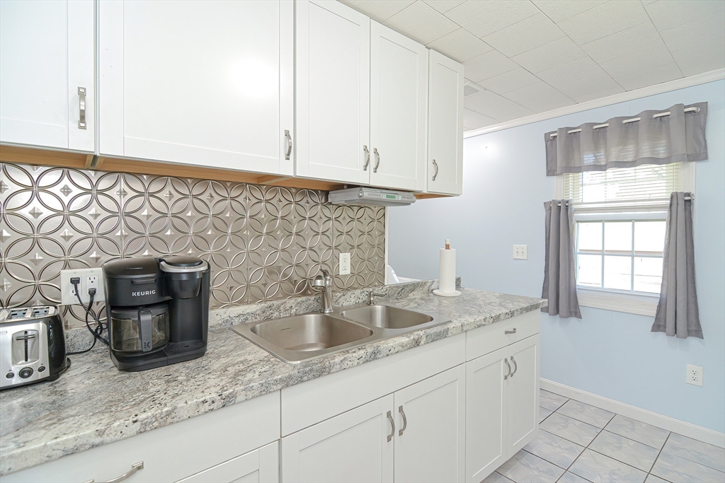 221 Smoke Rise Circle Swansea, MA 02777 - Photo 10 of 25 a kitchen with sink and cabinets