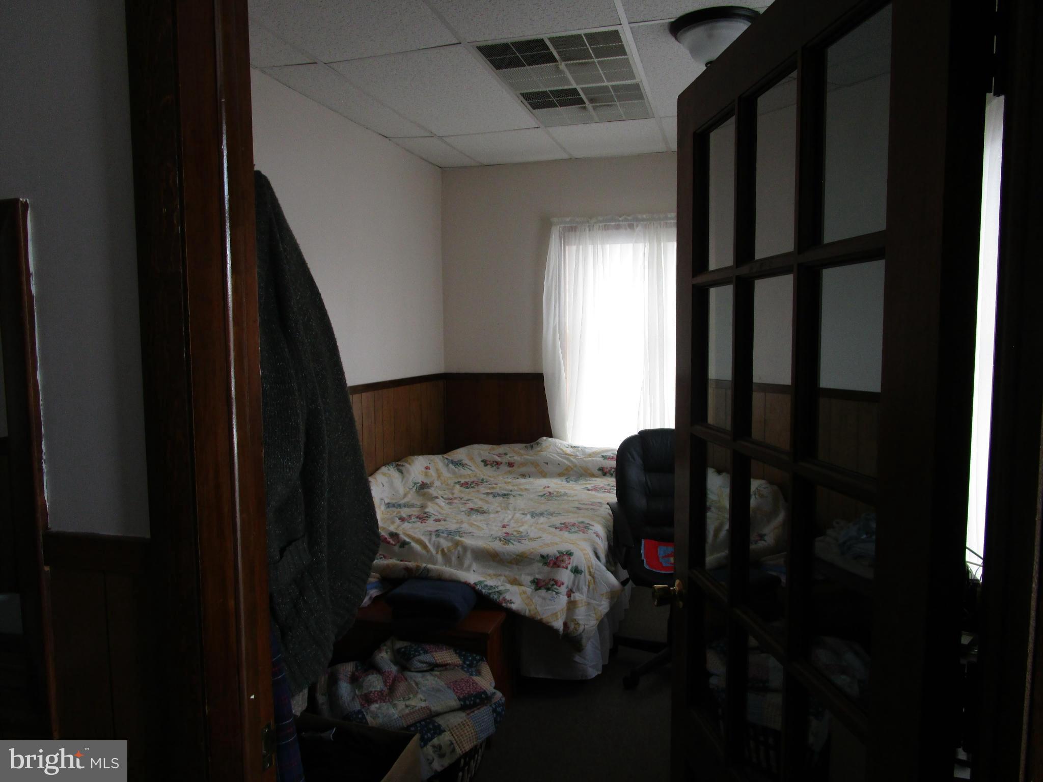 25331 Military Road Cascade, MD 21719 - Photo 13 of 13 a bedroom with a bed and a window