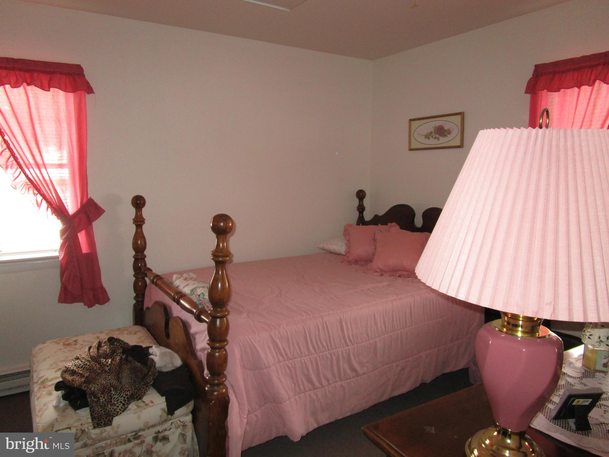 25331 Military Road Cascade, MD 21719 - Photo 7 of 13 a bedroom with a bed and window