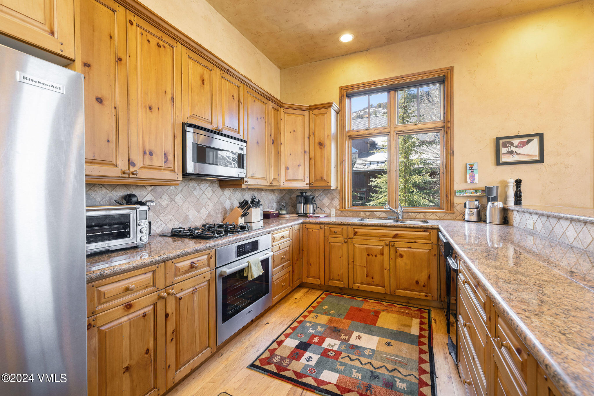 54 Cresta Road, Unit F6 Edwards, CO 81632 - Photo 5 of 13 a kitchen with stainless steel appliances granite countertop a stove a sink and a microwave