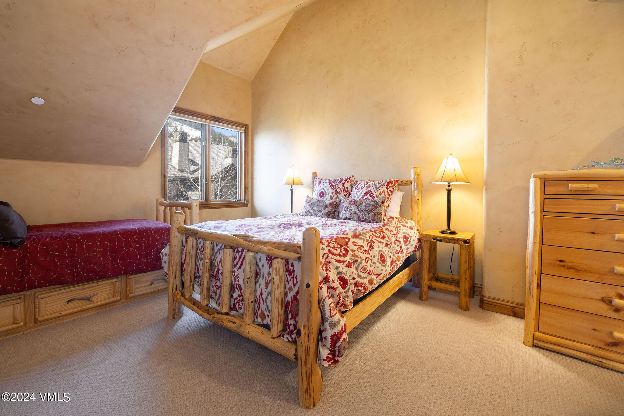 54 Cresta Road, Unit F6 Edwards, CO 81632 - Photo 9 of 13 a bed sitting in a bedroom next to a window