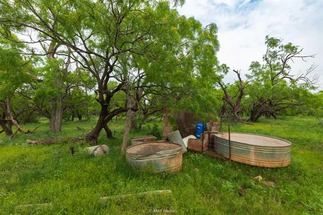 a view of a backyard with table and chairs and a fire pit