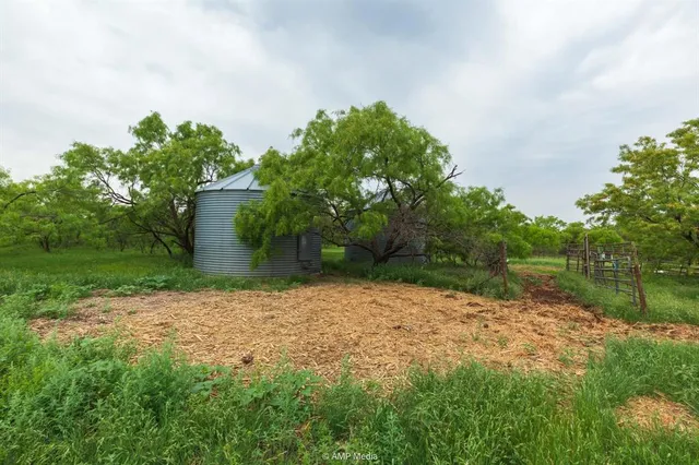 a backyard of a house with lots of green space and lake view