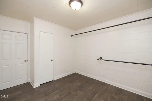 an empty room with wooden floor