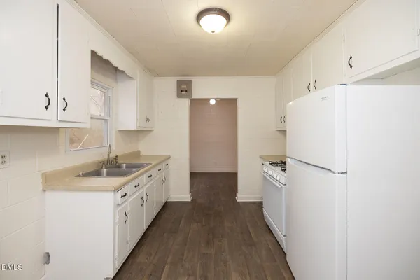 a kitchen with a white cabinets stove and refrigerator