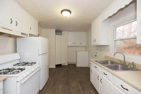 a kitchen with sink a stove and refrigerator