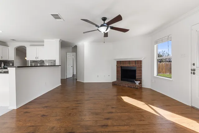 a view of a kitchen with a stove cabinets and wooden floor