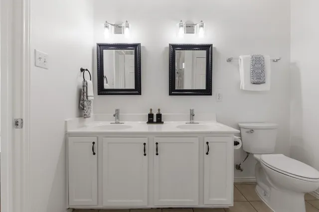 a bathroom with 2 sink and a toilet