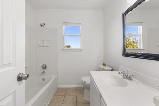 a bathroom with a sink a toilet and bathtub