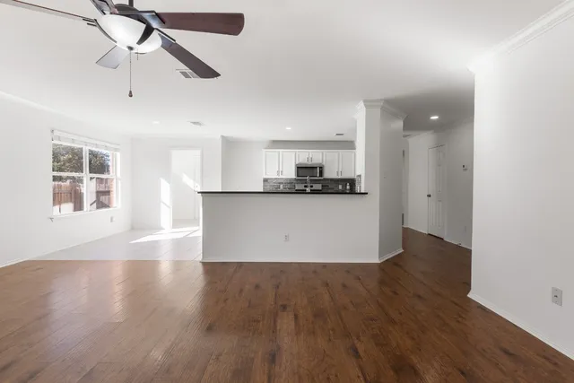 a view of a kitchen with a stove cabinets and wooden floor
