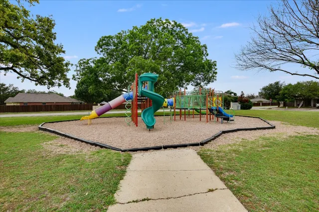a view of a big yard with a large trees