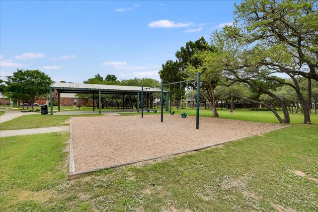 a view of a park with swings and slides