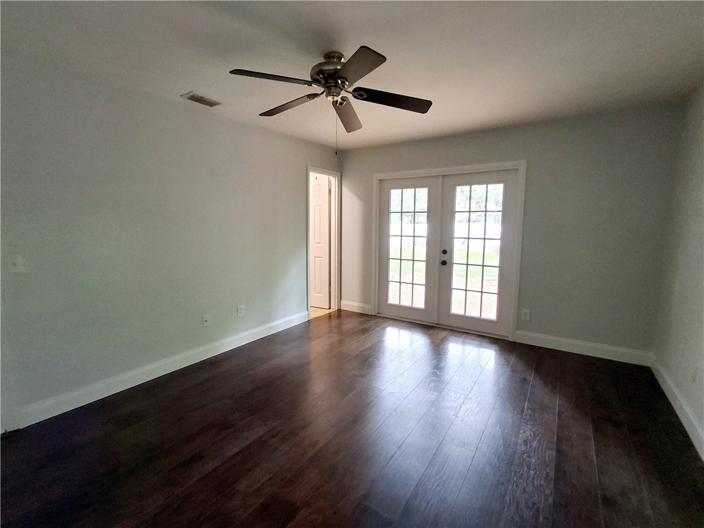 1110 10th Place Vero Beach, FL 32960 - Photo 11 of 18 a view of an empty room with wooden floor and a window