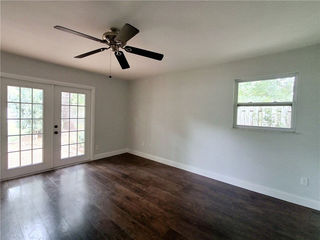 1110 10th Place Vero Beach, FL 32960 - Photo 12 of 18 a view of an empty room with wooden floor and a window