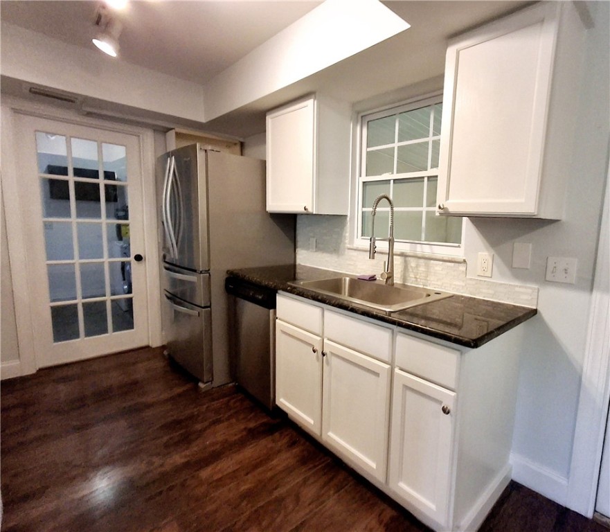 1110 10th Place Vero Beach, FL 32960 - Photo 9 of 18 a kitchen with granite countertop a sink appliances cabinets and a counter top space