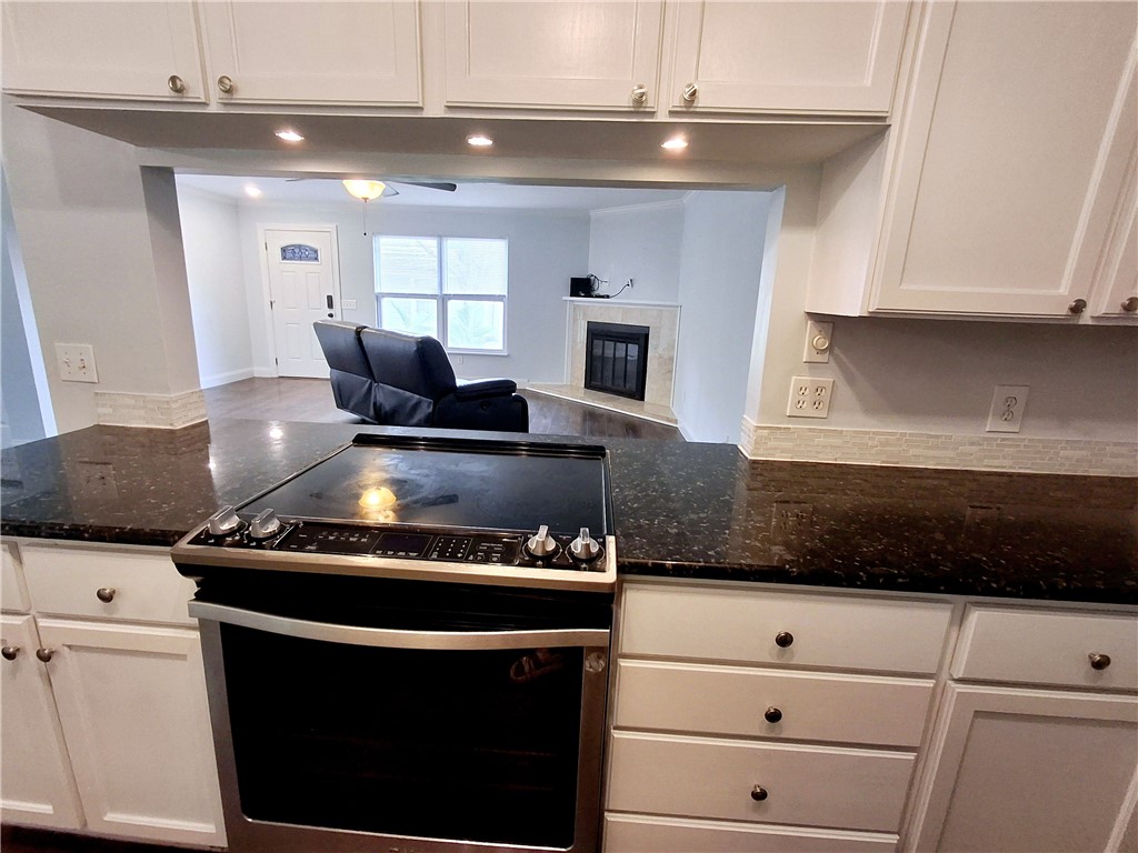 1110 10th Place Vero Beach, FL 32960 - Photo 10 of 18 a kitchen with a stove and white cabinets