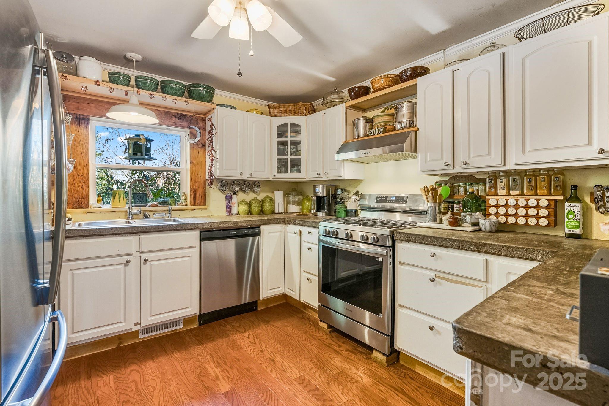 13 Holly Hill Farm Road Mars Hill, NC 28754 - Photo 11 of 44 a kitchen with stainless steel appliances granite countertop a stove a sink and a refrigerator