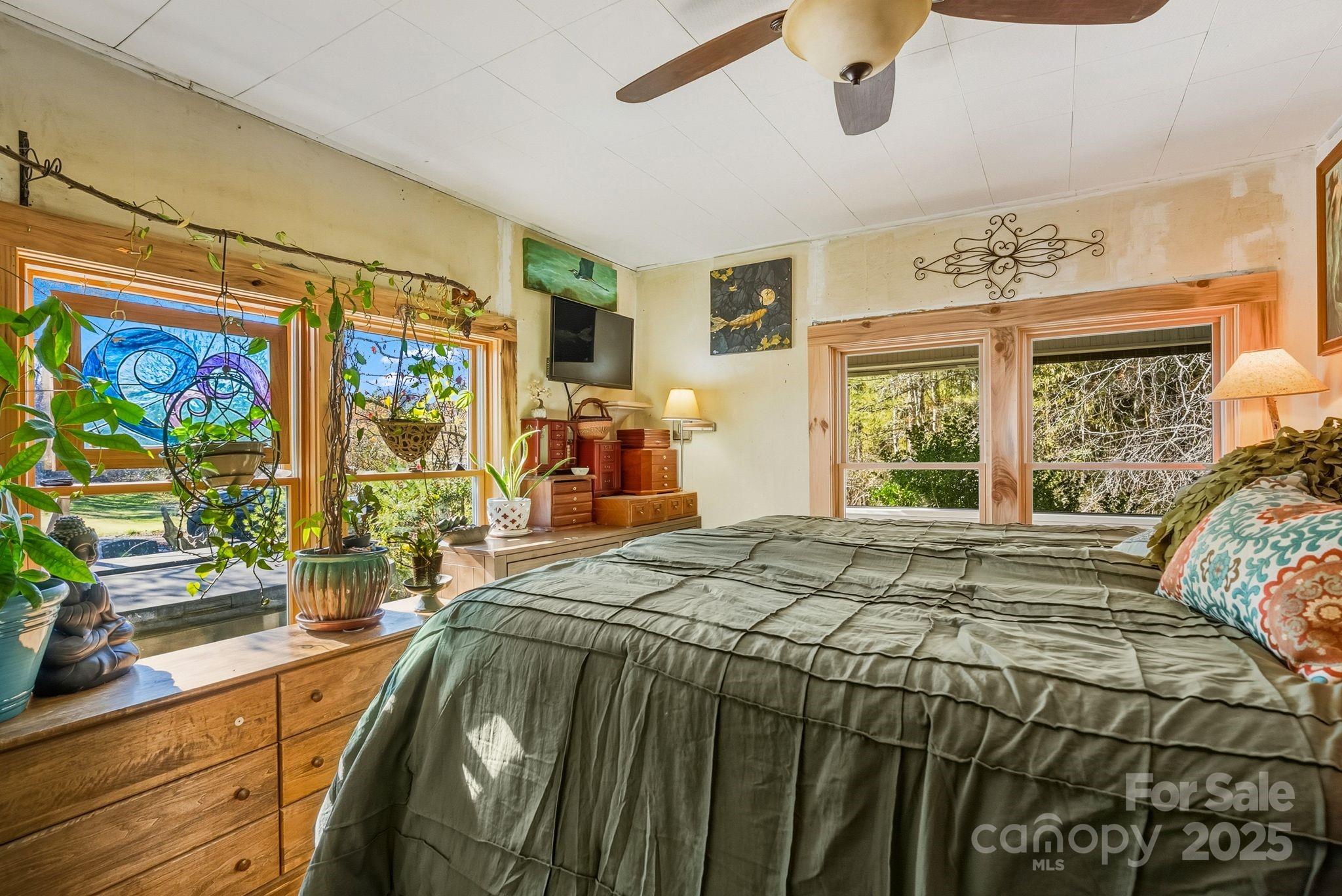 13 Holly Hill Farm Road Mars Hill, NC 28754 - Photo 15 of 44 a bed sitting in a bedroom next to a window
