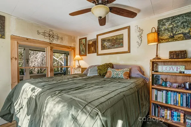 a bed sitting in a bedroom next to a book shelf