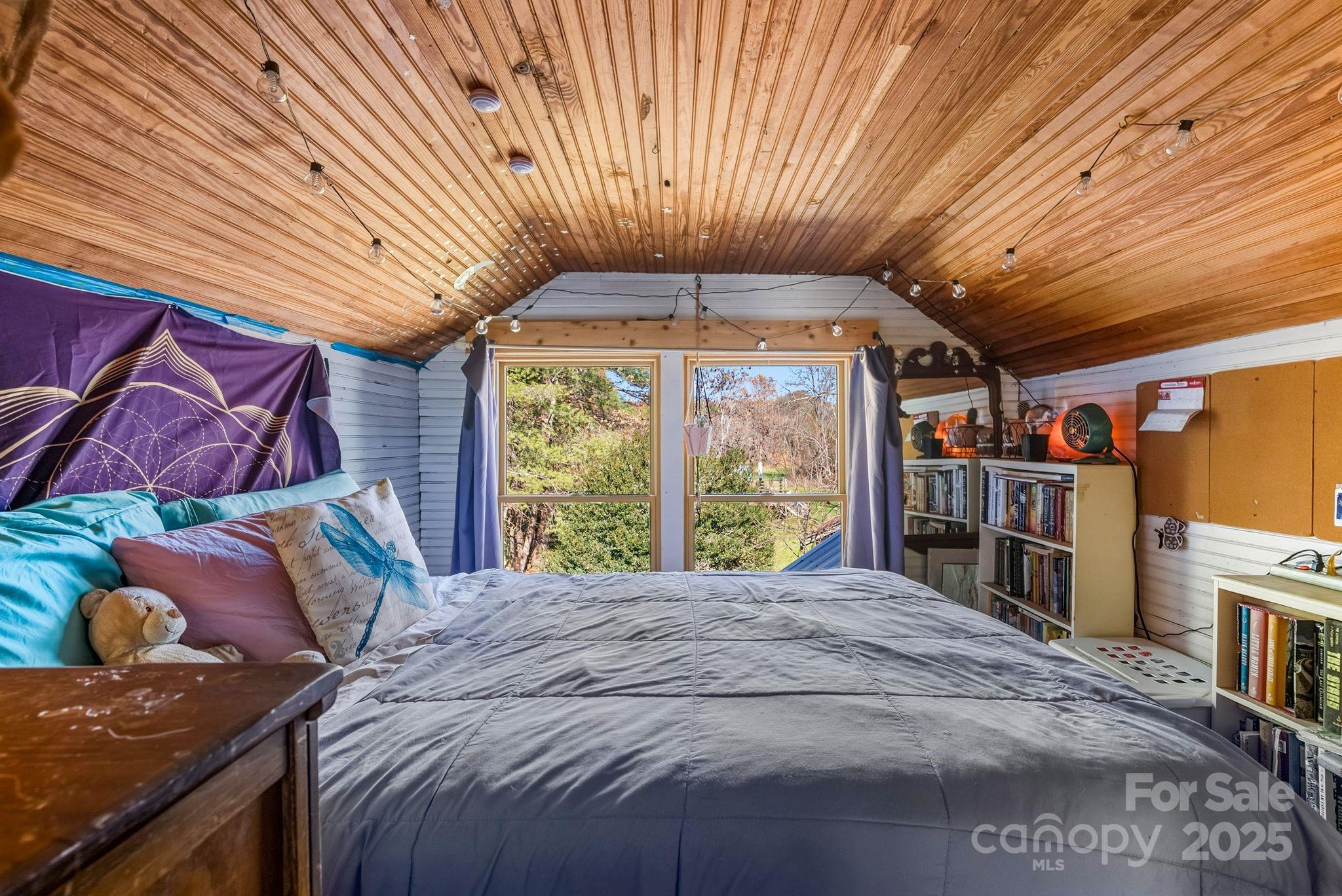 13 Holly Hill Farm Road Mars Hill, NC 28754 - Photo 19 of 44 a bed sitting in a bedroom next to a window