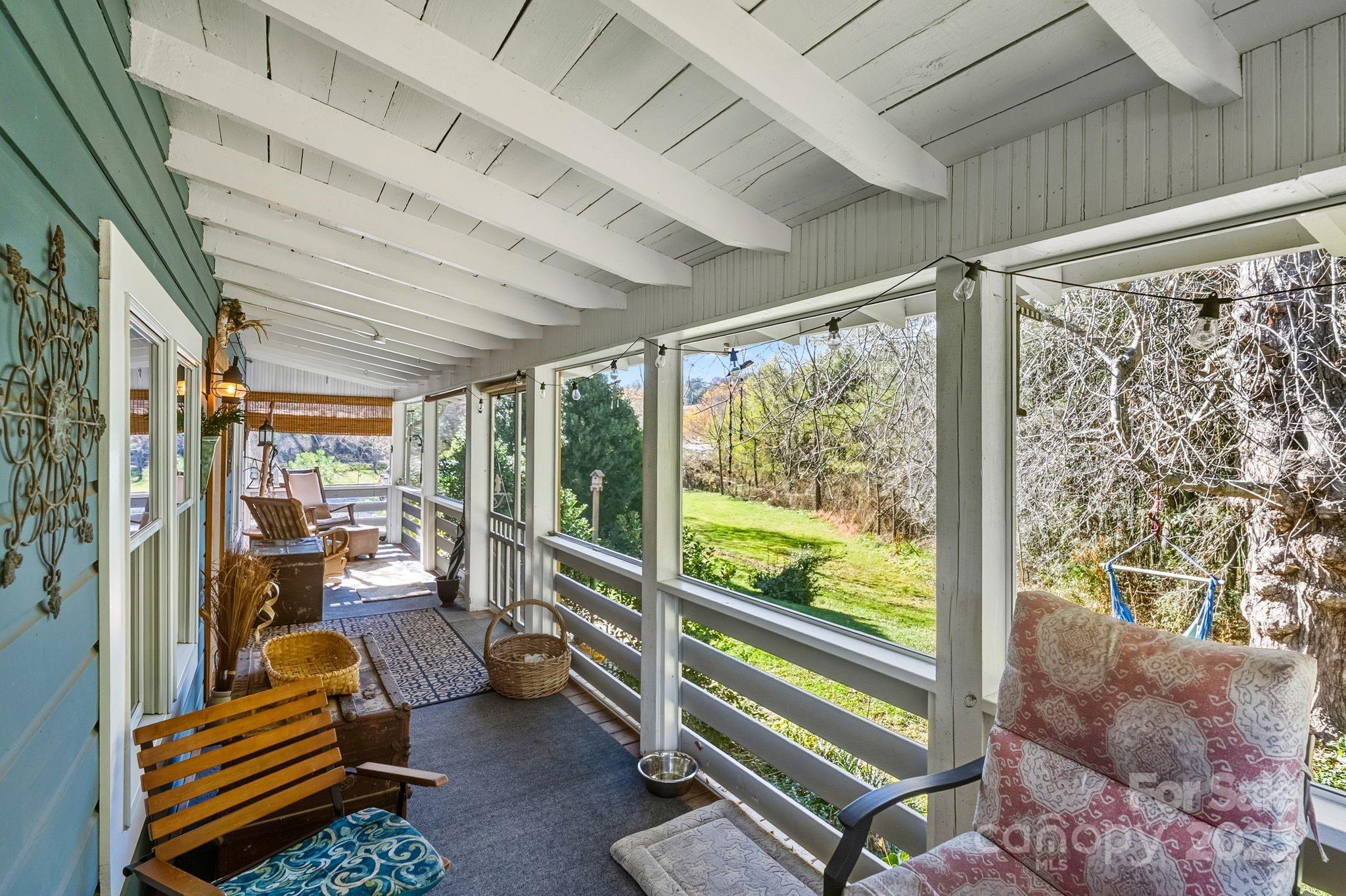 13 Holly Hill Farm Road Mars Hill, NC 28754 - Photo 24 of 44 a room with lots of trees and furniture