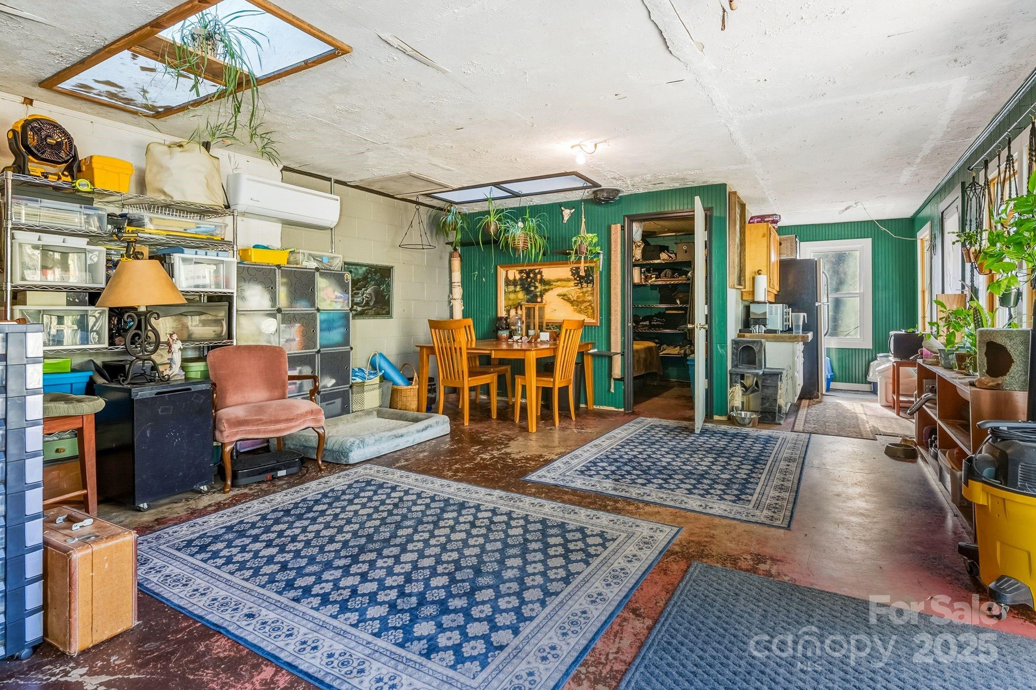13 Holly Hill Farm Road Mars Hill, NC 28754 - Photo 25 of 44 a living room with lots of furniture and a rug