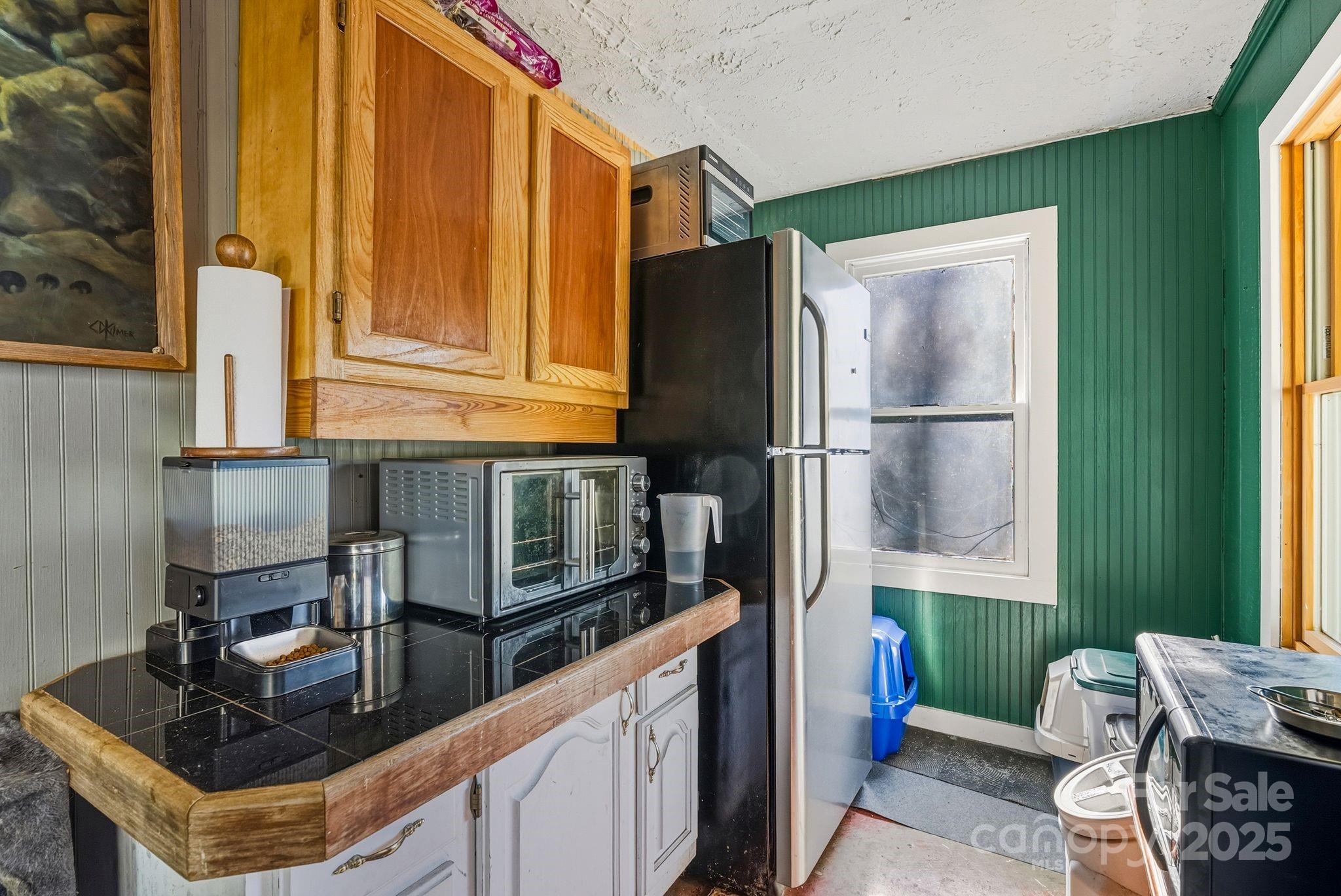 13 Holly Hill Farm Road Mars Hill, NC 28754 - Photo 26 of 44 a kitchen with stainless steel appliances granite countertop a refrigerator a stove and a sink with wooden floor
