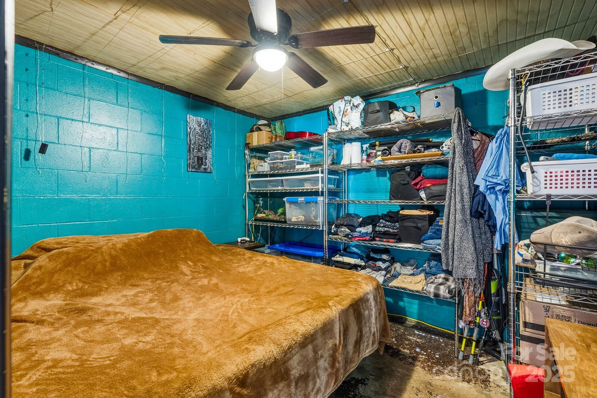 13 Holly Hill Farm Road Mars Hill, NC 28754 - Photo 28 of 44 a bedroom with bed and a chandelier