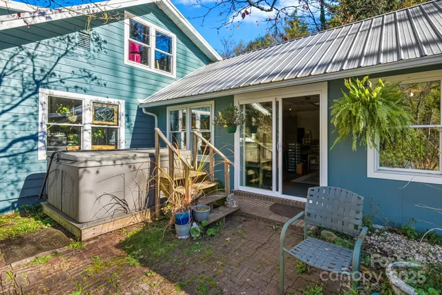 a view of a house with a yard and sitting area