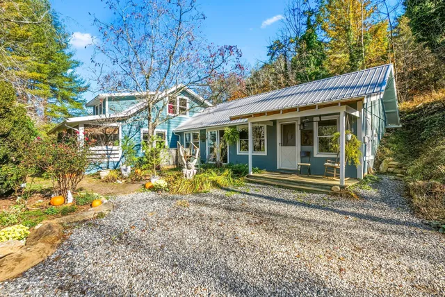 a view of a house with backyard porch and sitting area