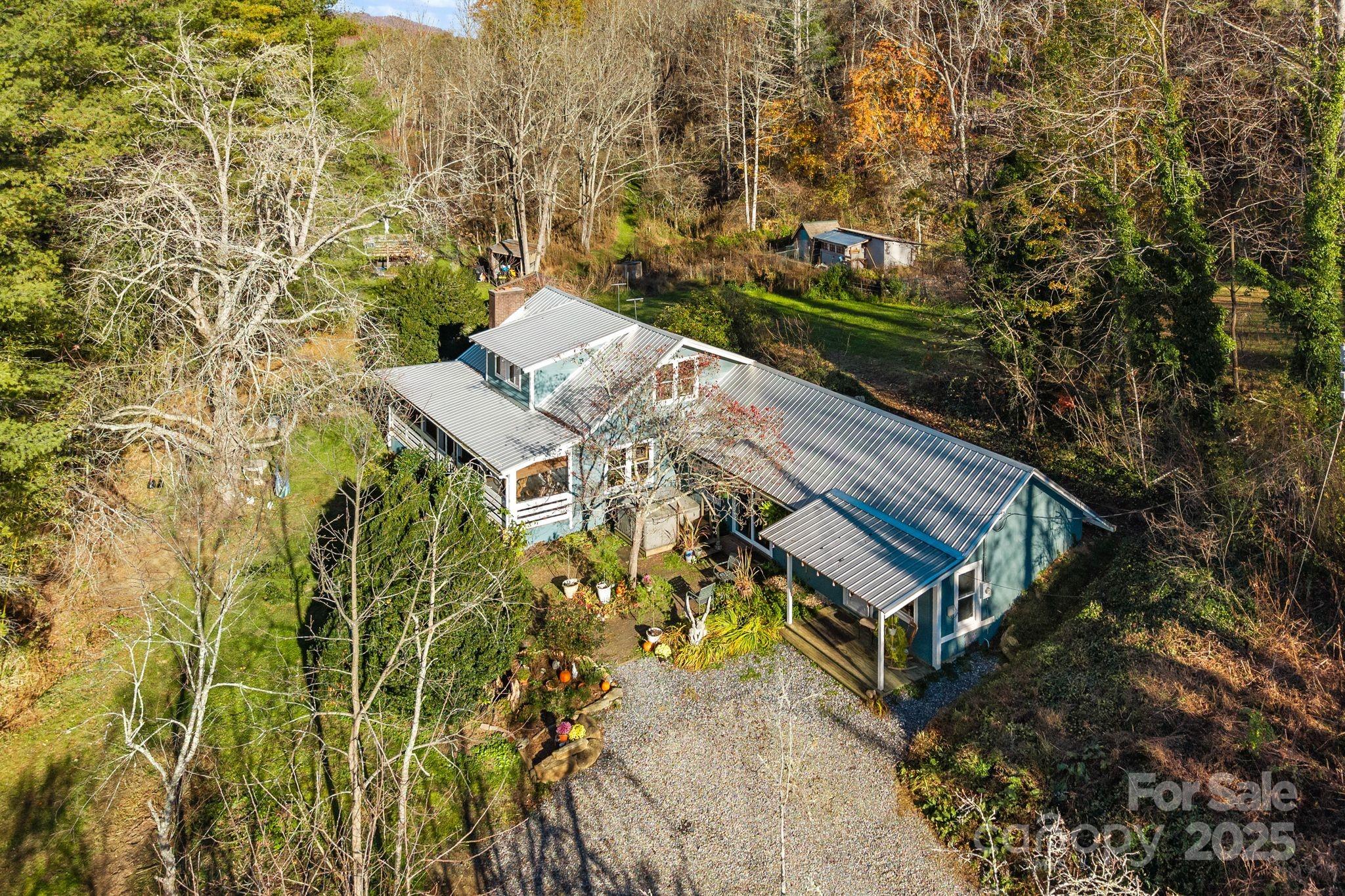 13 Holly Hill Farm Road Mars Hill, NC 28754 - Photo 34 of 44 a view of a house with a yard and large trees
