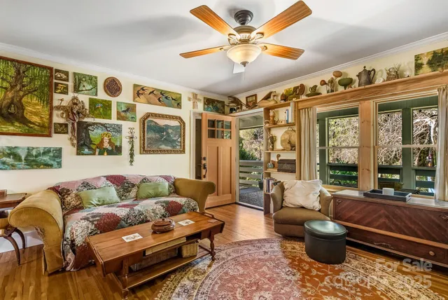 a living room with furniture and a large window with garden view