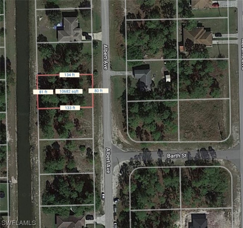 903 Albert Avenue Lehigh Acres, FL 33971 - Photo 7 of 7 a bathroom with a glass shower door