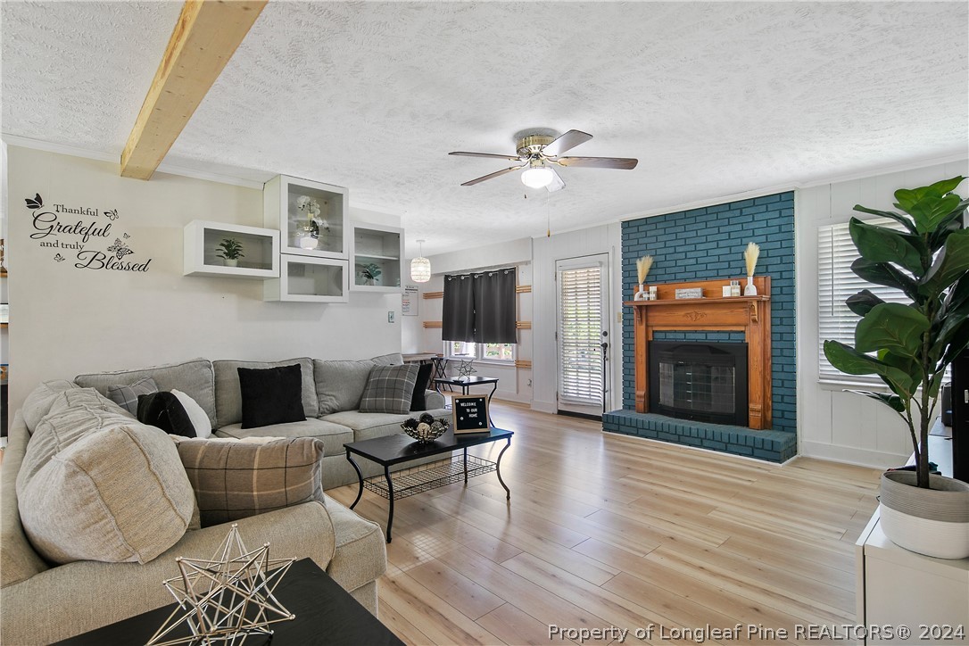 3011 Rouse Road Fayetteville, NC 28306 - Photo 12 of 50 a living room with furniture a fireplace and a flat screen tv