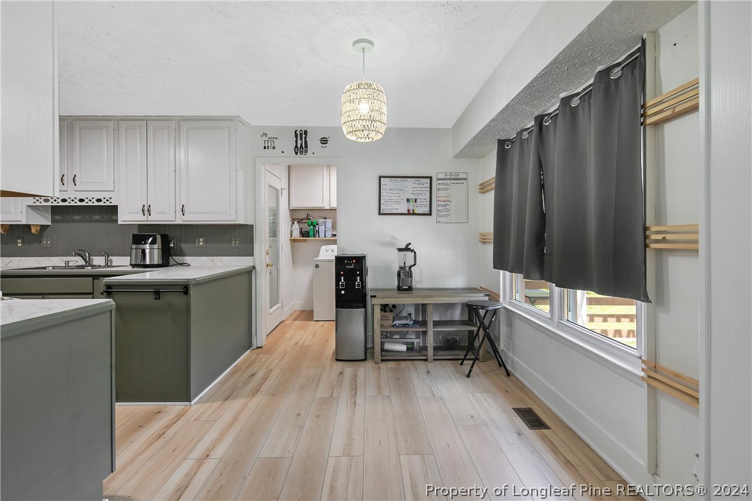 3011 Rouse Road Fayetteville, NC 28306 - Photo 17 of 50 a kitchen with granite countertop a refrigerator stove top oven and sink
